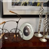 D13. Model tricycle, Tara picture frame and metal candlesticks. 